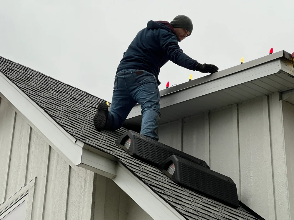 professional installing holiday lighting